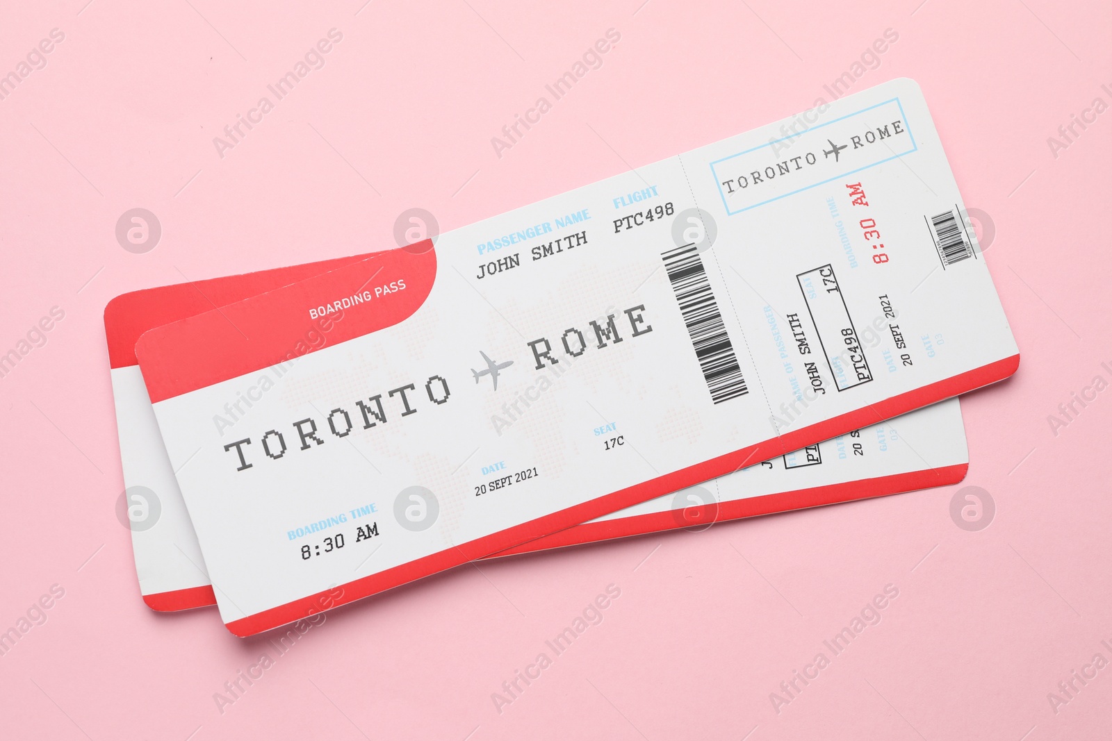 Photo of Travel agency. Flight tickets on pink background, top view