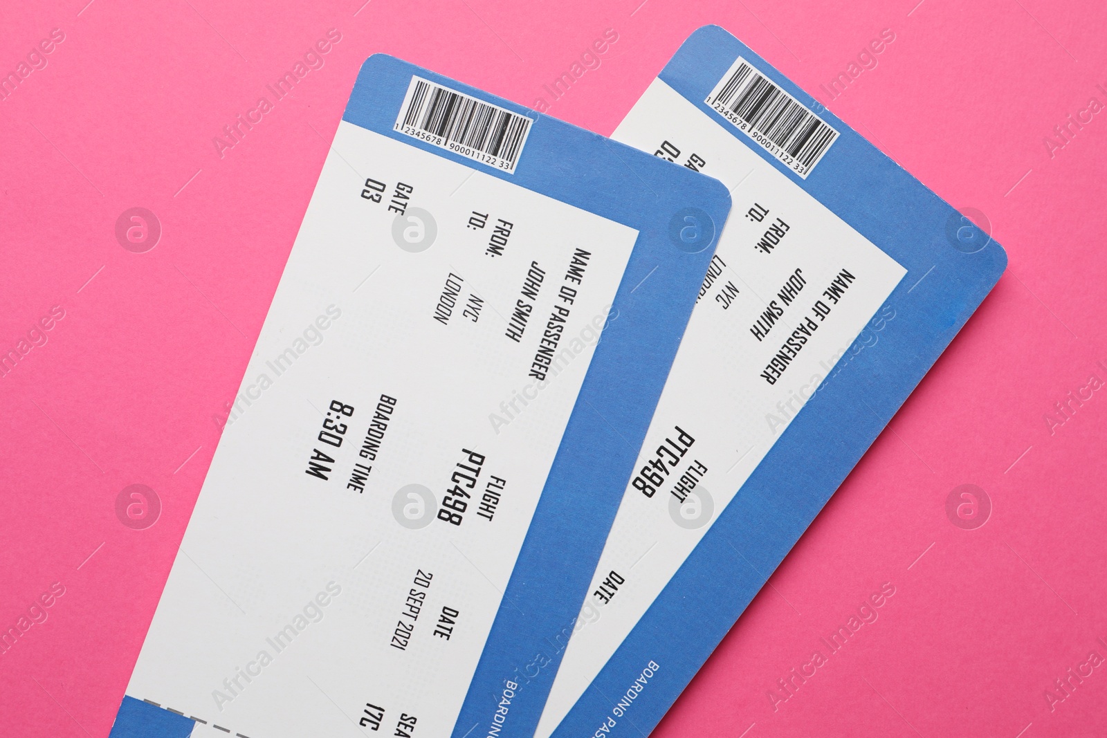 Photo of Travel agency. Flight tickets on pink background, top view