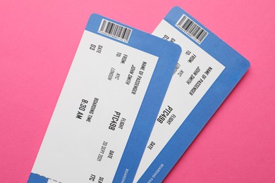 Photo of Travel agency. Flight tickets on pink background, top view