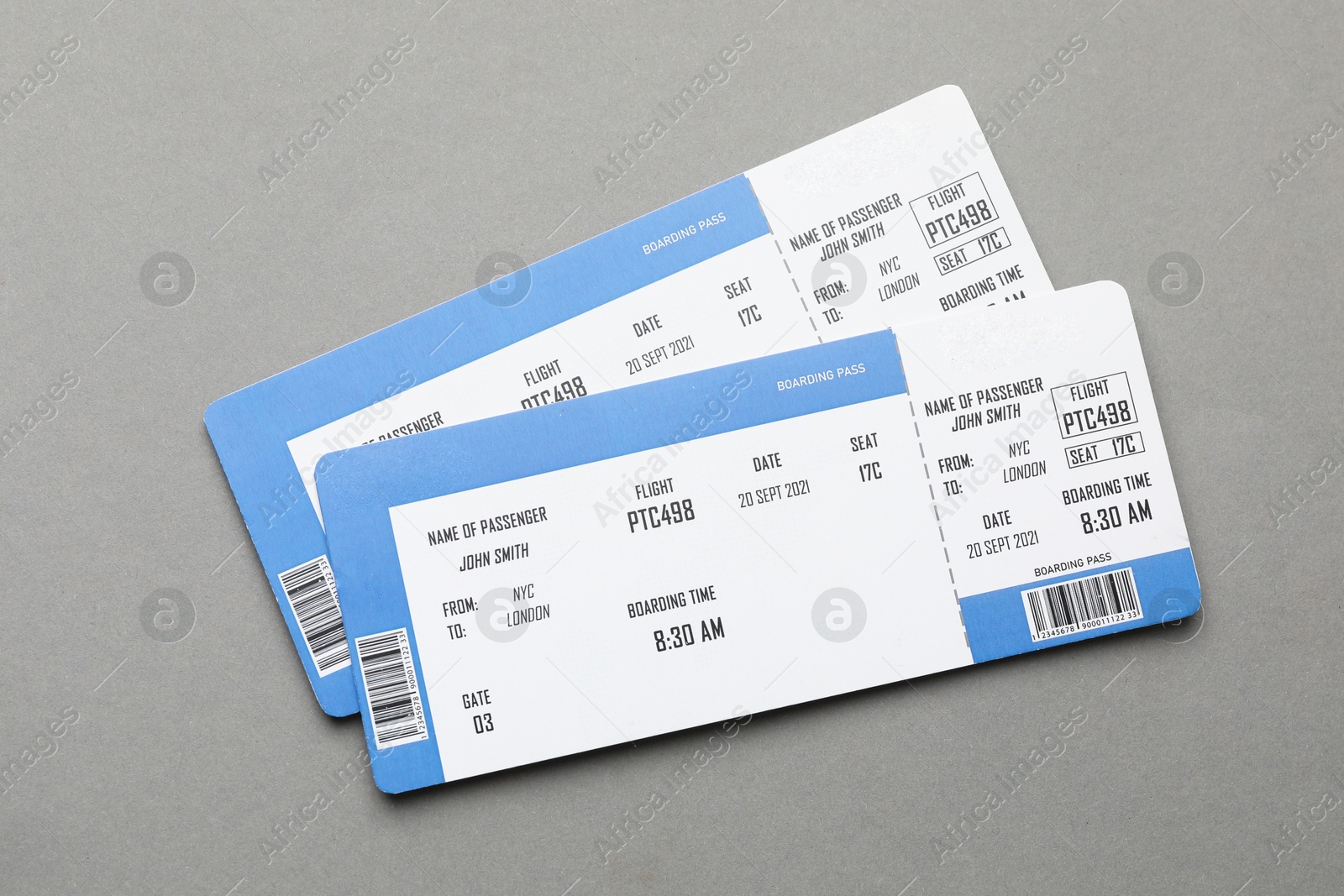 Photo of Travel agency. Flight tickets on grey background, top view