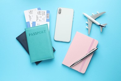 Photo of Travel agency. Flat lay composition with flight tickets on light blue background