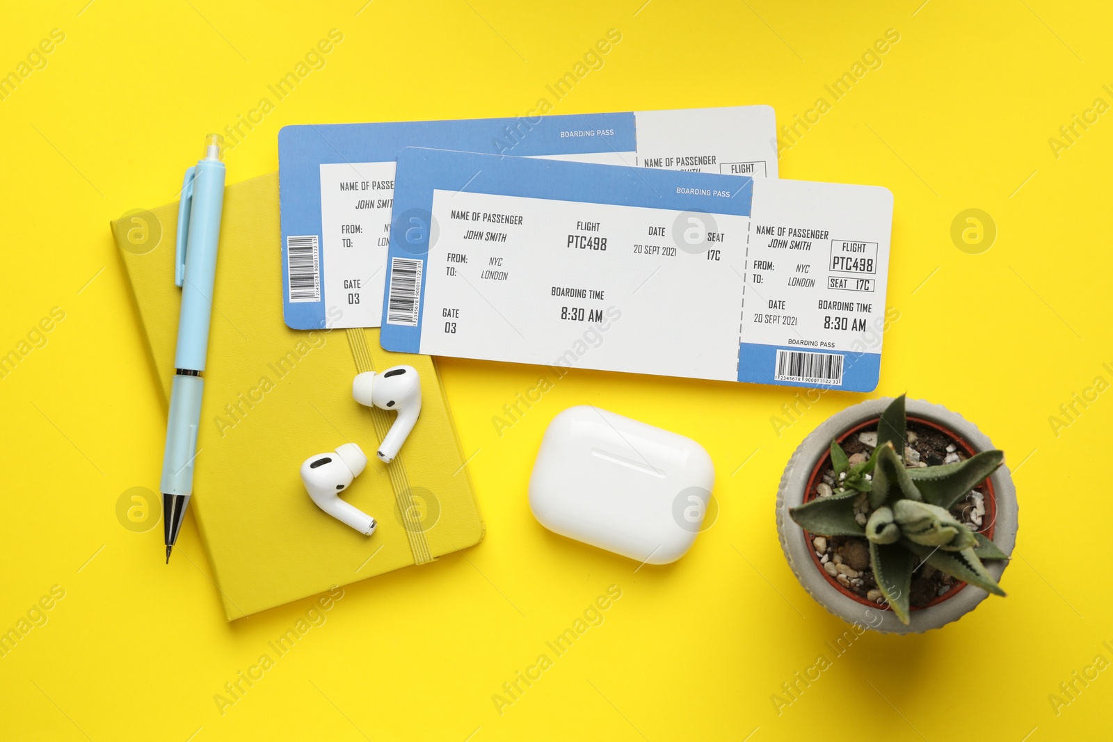 Photo of Travel agency. Flat lay composition with flight tickets on yellow background