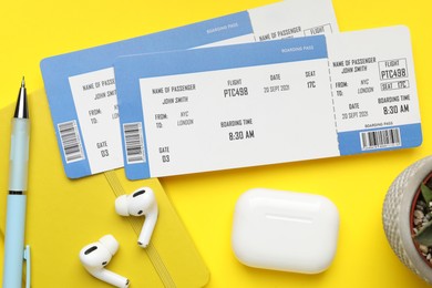 Photo of Travel agency. Flat lay composition with flight tickets on yellow background