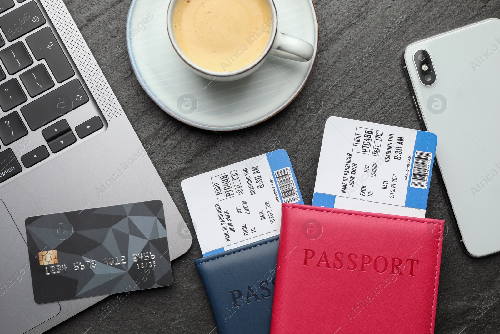 Photo of Travel agency. Flat lay composition with flight tickets and credit card on dark textured table