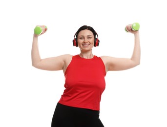 Photo of Plus size woman in gym clothes doing exercise with dumbbells on white background