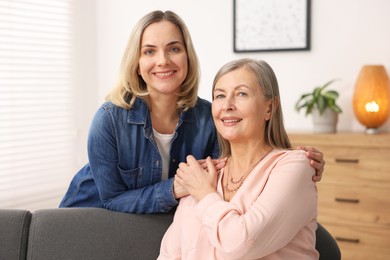 Photo of Smiling mother and her daughter at home