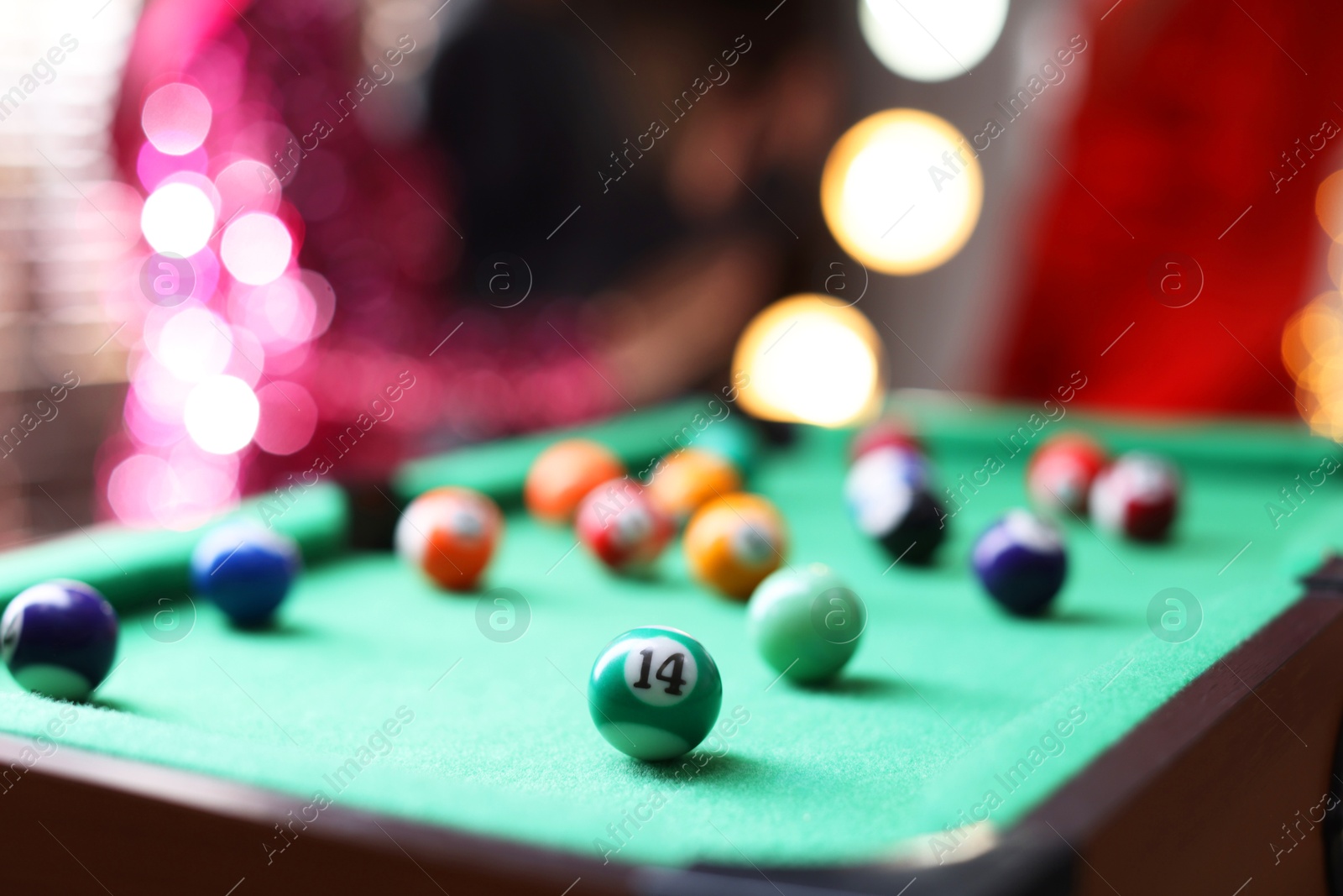 Photo of Many colorful billiard balls on green table indoors, closeup. Space for text