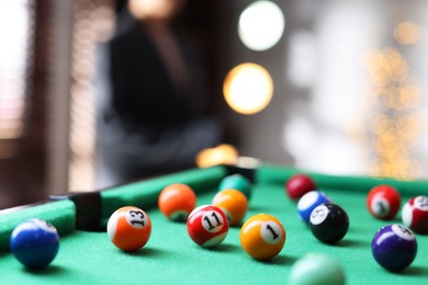 Photo of Many colorful billiard balls on green table indoors, closeup. Space for text