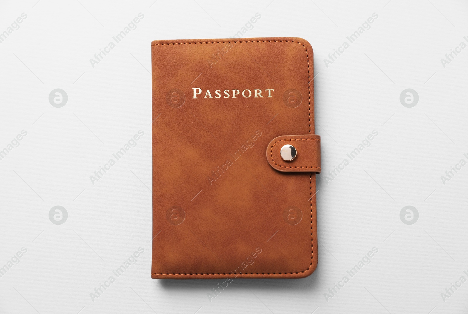 Photo of Passport in leather cover on grey background, top view