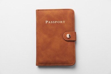 Photo of Passport in leather cover on grey background, top view