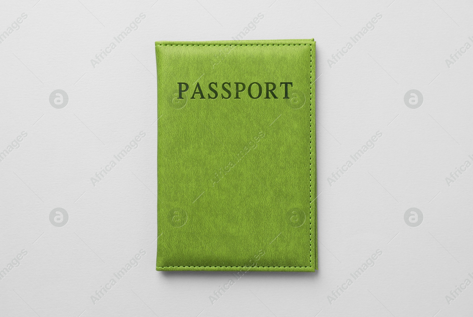 Photo of Passport in bright cover on grey background, top view