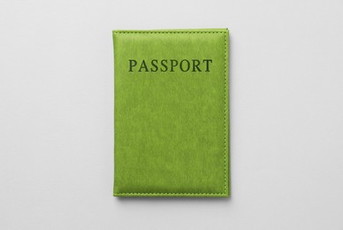 Photo of Passport in bright cover on grey background, top view