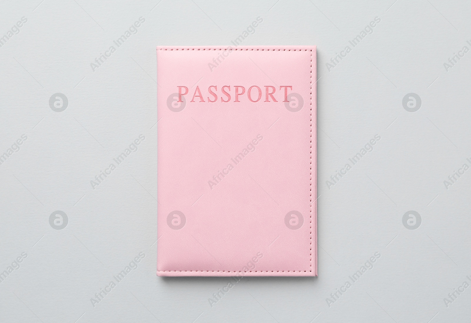 Photo of Passport in bright cover on grey background, top view