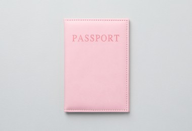 Photo of Passport in bright cover on grey background, top view