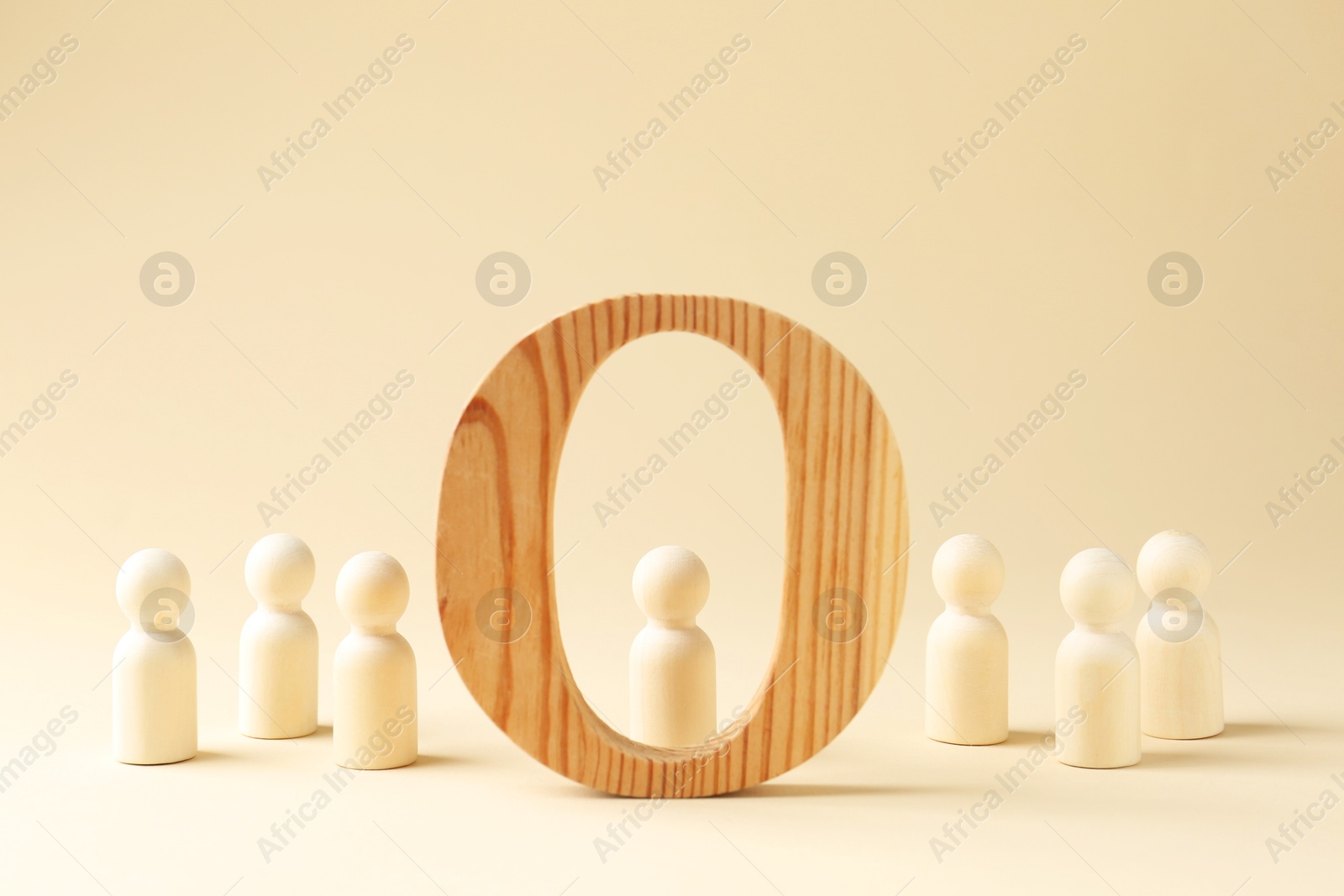 Photo of Competition concept. Human figures and wooden circle on beige background