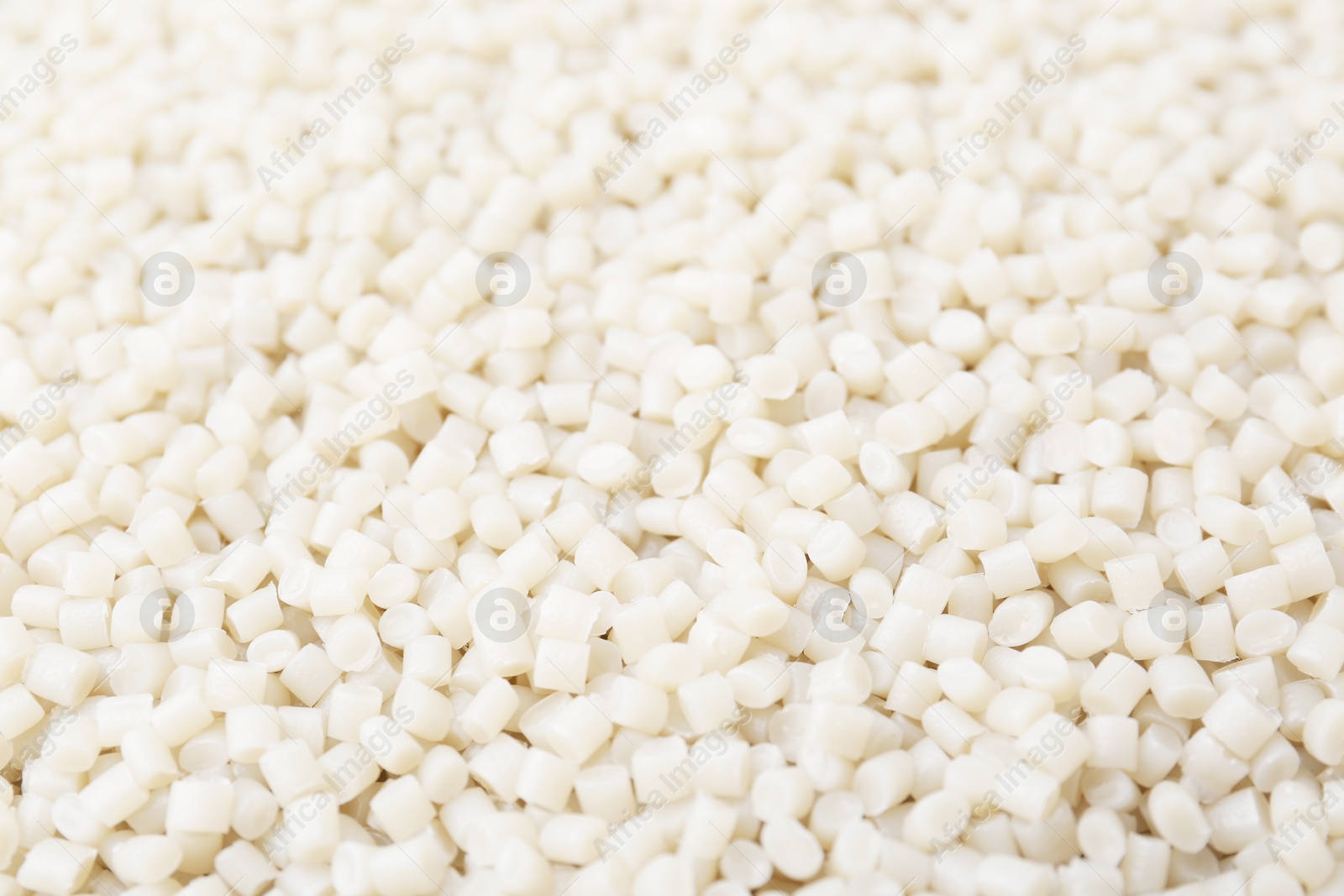 Photo of Pile of plastic granules as background, closeup