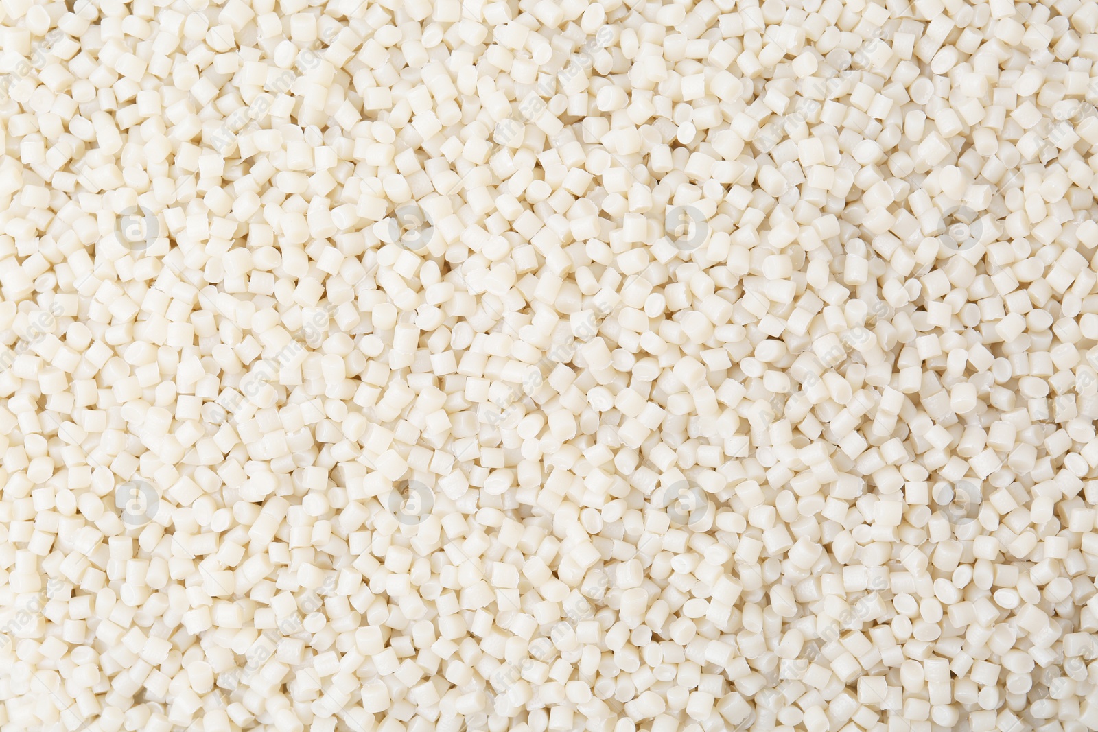 Photo of Pile of plastic granules as background, top view