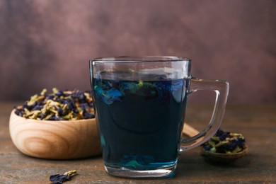 Delicious butterfly pea flower tea on wooden table