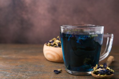 Delicious butterfly pea flower tea on wooden table. Space for text