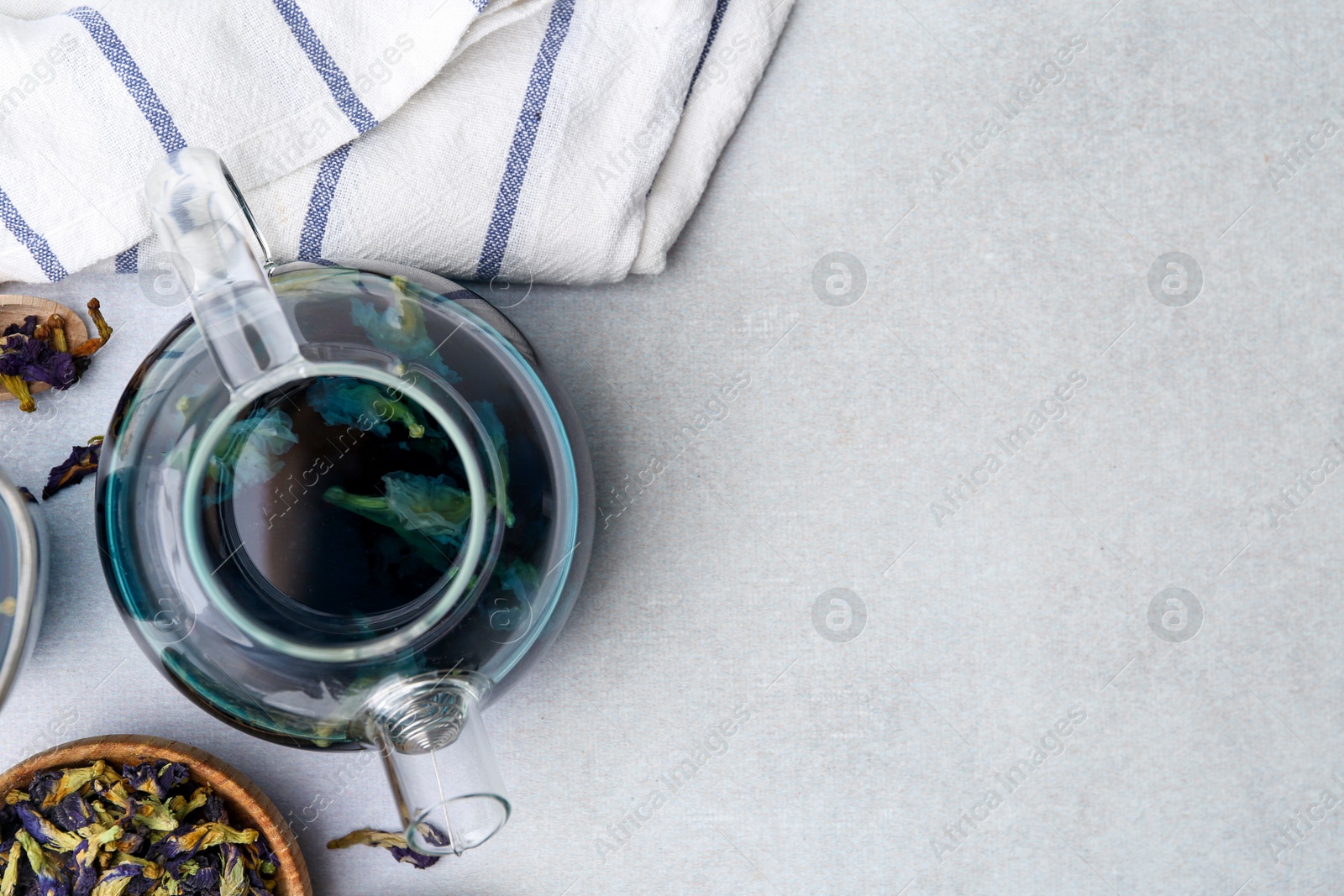 Photo of Delicious butterfly pea flower tea on white table, flat lay. Space for text