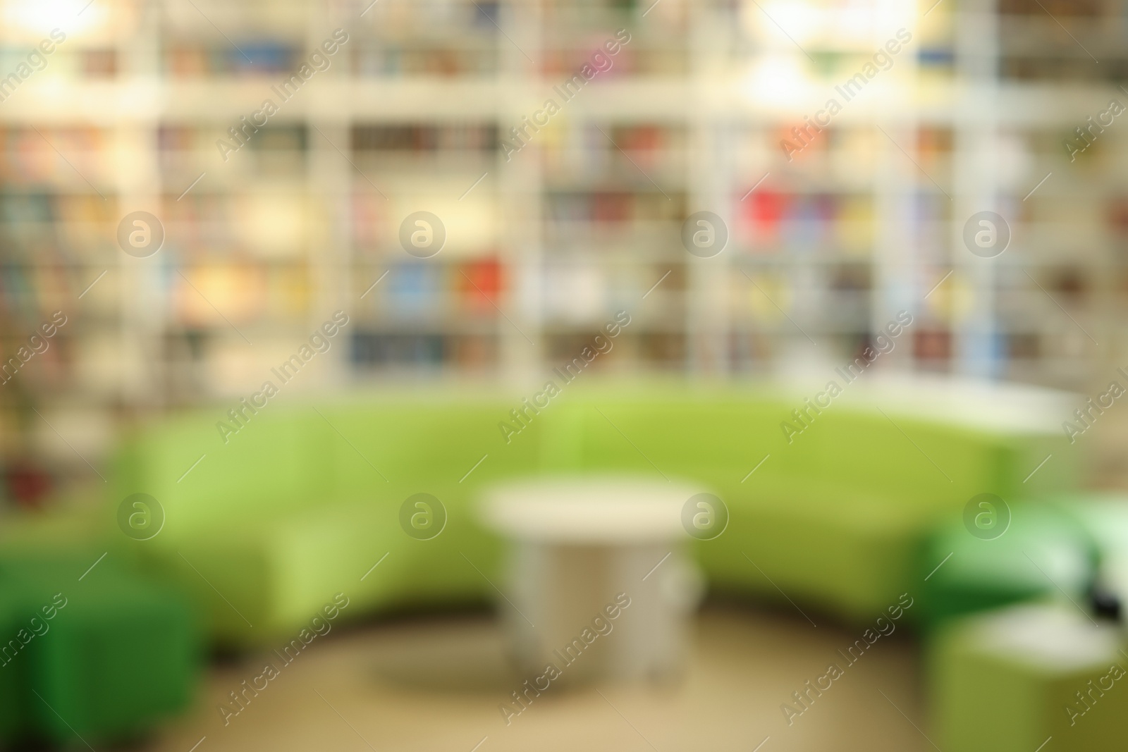 Photo of Stylish furniture in public library, blurred view