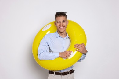 Photo of Businessman with inflatable ring on white background