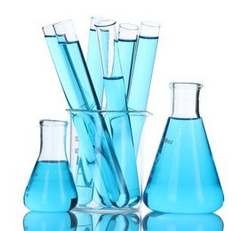 Photo of Laboratory glassware with blue liquid isolated on white