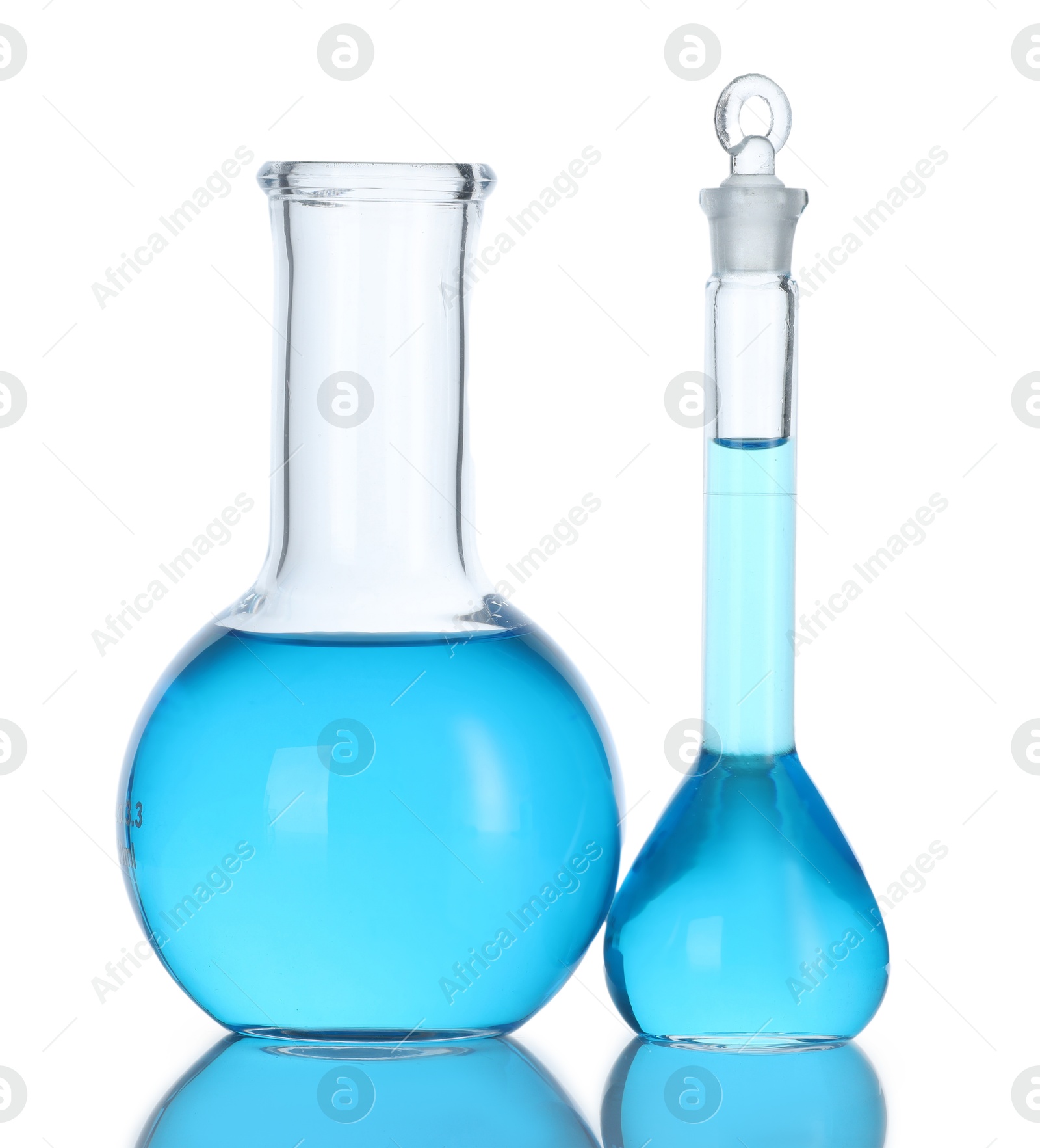 Photo of Flasks with blue liquid isolated on white. Laboratory glassware