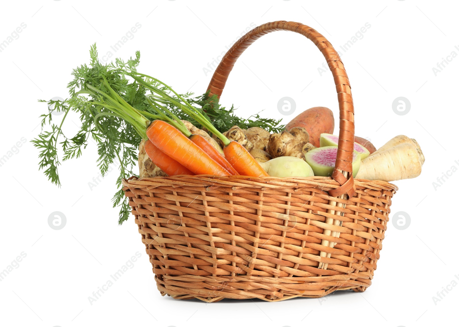 Photo of Different root vegetables in wicker basket isolated on white