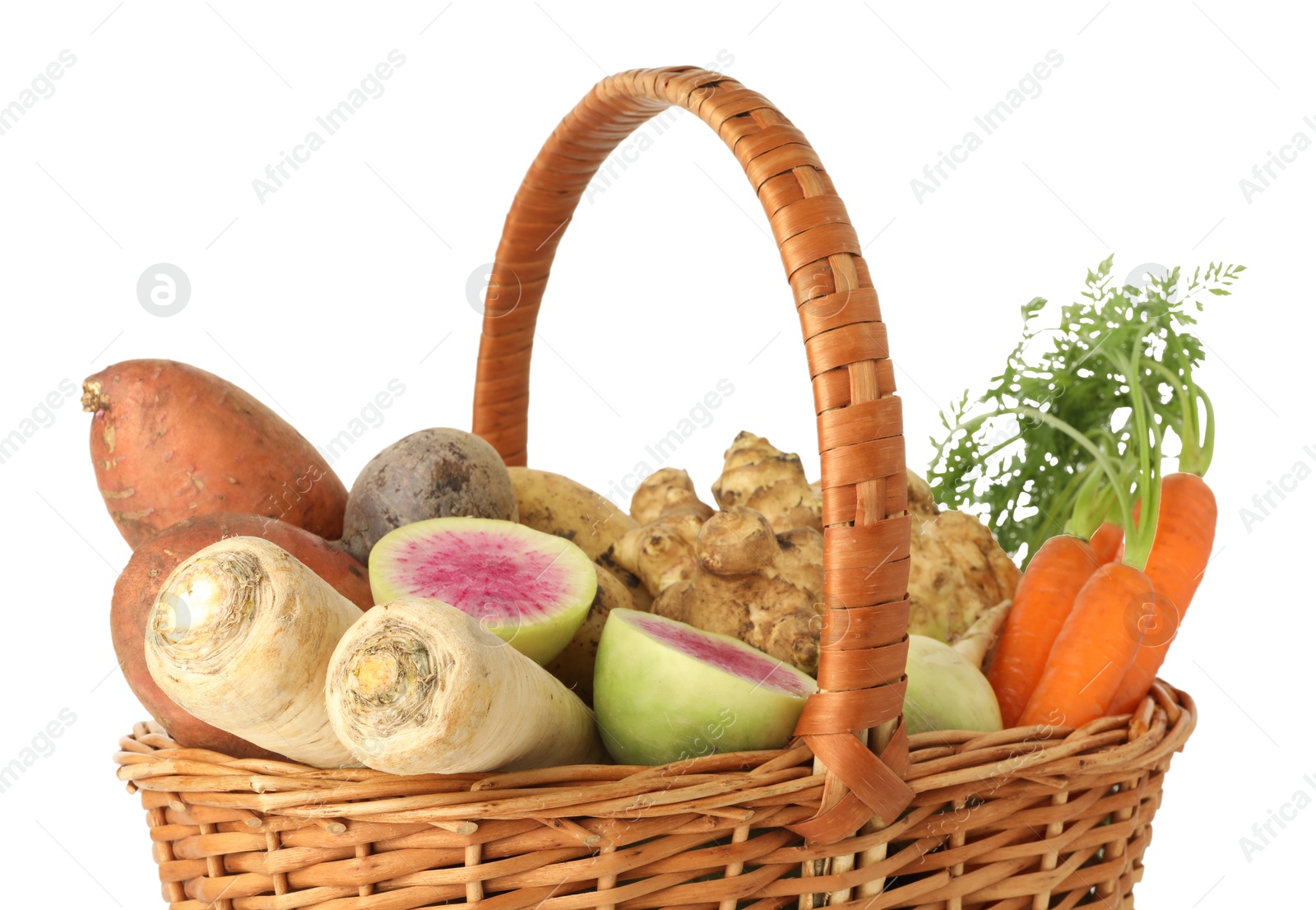 Photo of Different root vegetables in wicker basket isolated on white