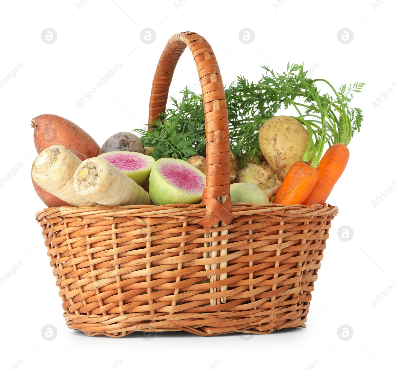 Photo of Different root vegetables in wicker basket isolated on white