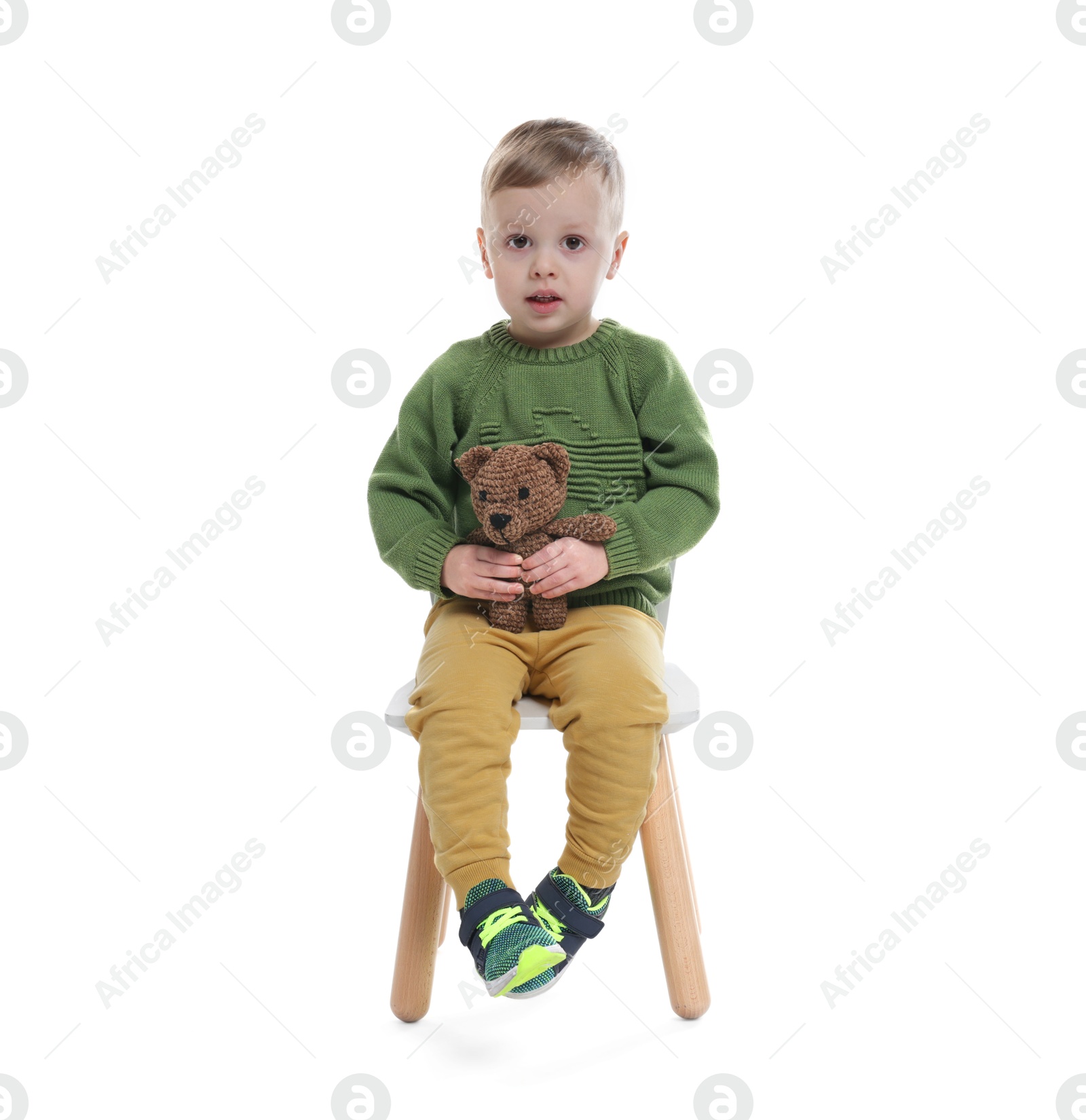 Photo of Cute little boy with toy bear on white background