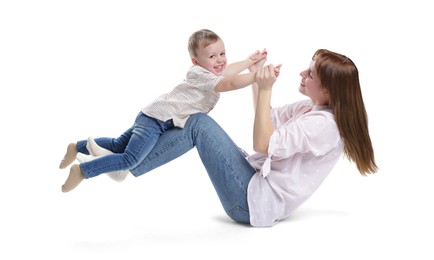 Photo of Mother and her cute son having fun on white background