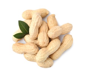 Photo of Pile of unpeeled peanuts isolated on white, top view