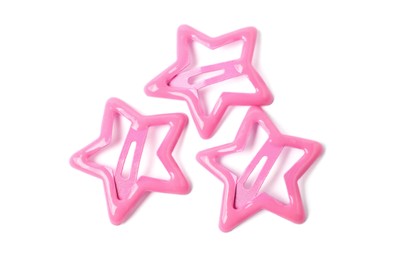 Photo of Many pink star shaped hair clips isolated on white, top view