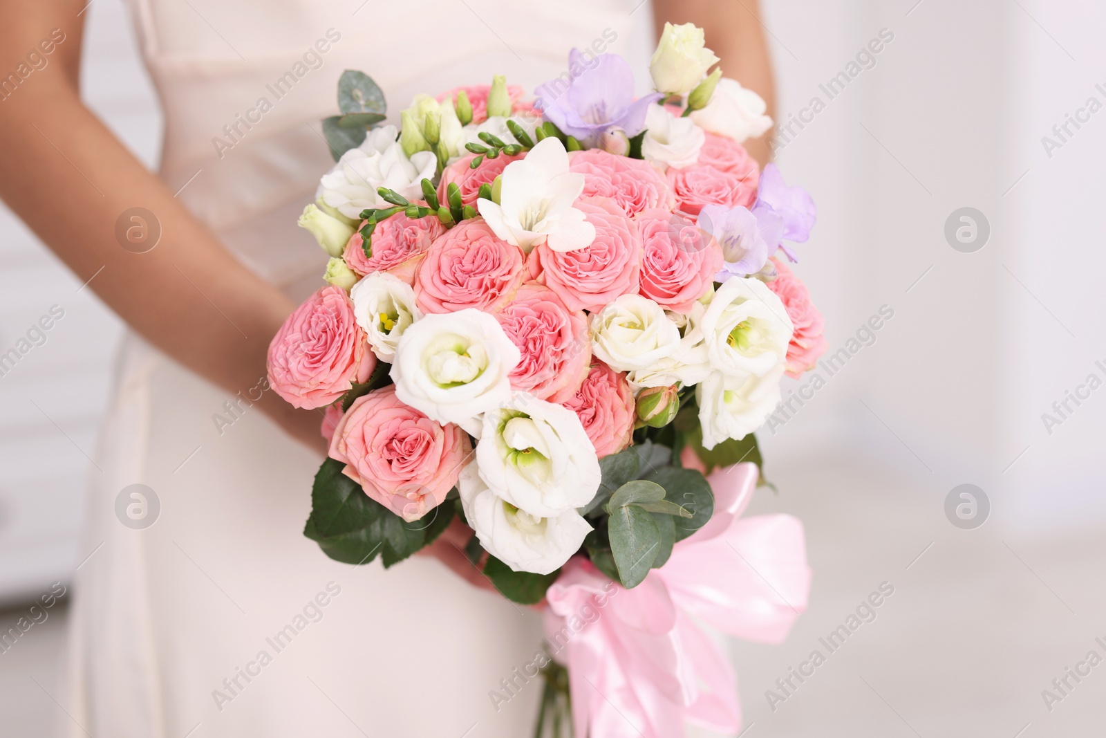 Photo of Bride with beautiful wedding bouquet on light background, closeup. Space for text