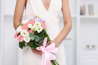 Photo of Bride with beautiful wedding bouquet indoors, closeup