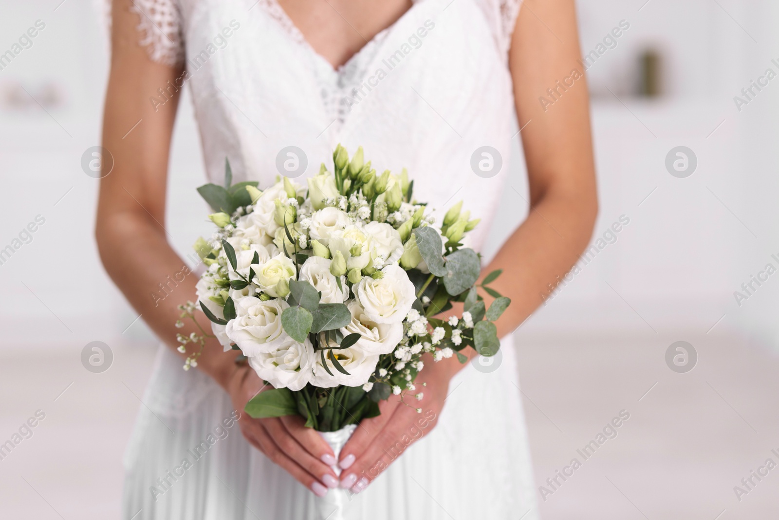 Photo of Bride with beautiful wedding bouquet on light background, closeup