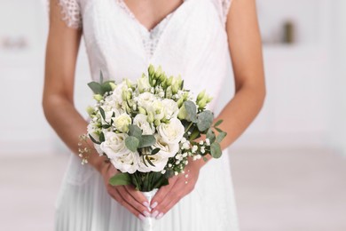 Photo of Bride with beautiful wedding bouquet on light background, closeup