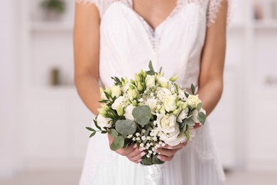 Photo of Bride with beautiful wedding bouquet on light background, closeup