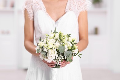 Photo of Bride with beautiful wedding bouquet on light background, closeup