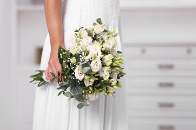 Photo of Bride with beautiful wedding bouquet on light background, closeup. Space for text