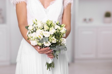 Photo of Bride with beautiful wedding bouquet on light background, closeup. Space for text