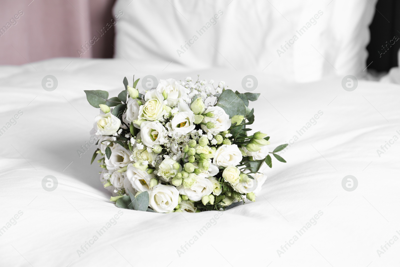 Photo of Wedding bouquet of beautiful flowers on bed indoors