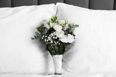 Photo of Wedding bouquet of beautiful flowers and pillows on bed