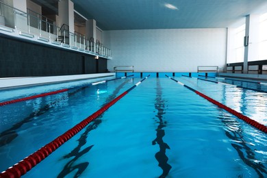 Photo of Swimming pool with clean water and lane dividers indoors