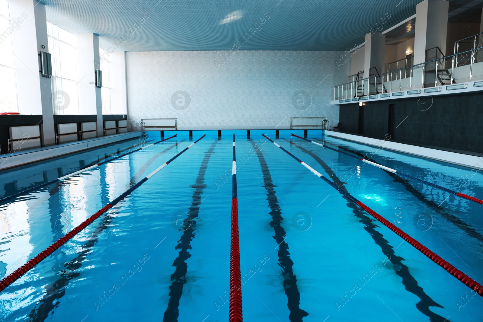 Photo of Swimming pool with clean water and lane dividers indoors