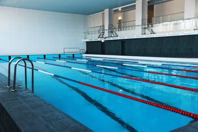 Photo of Swimming pool with clean water and lane dividers indoors