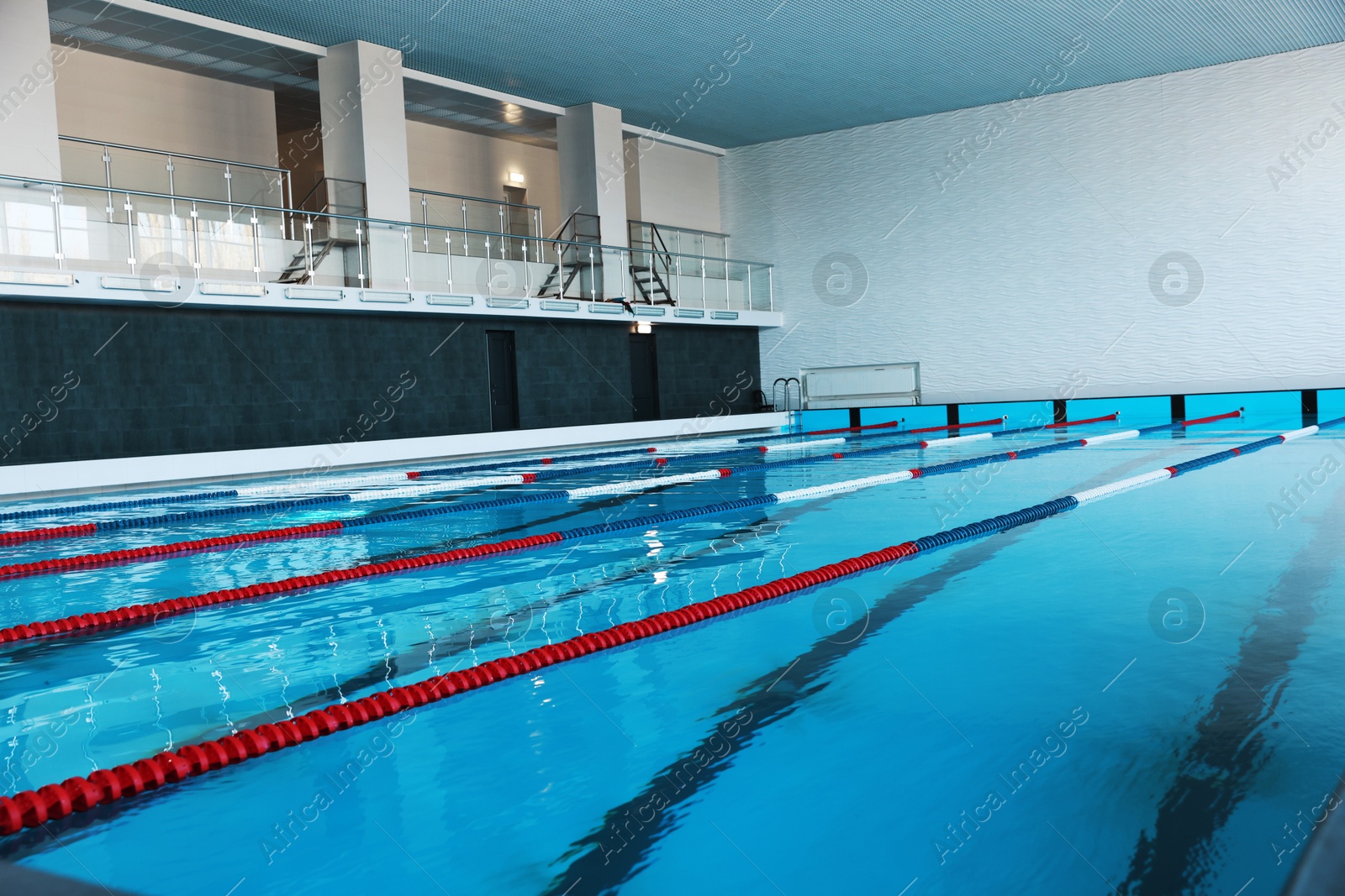 Photo of Swimming pool with clean water and lane dividers indoors