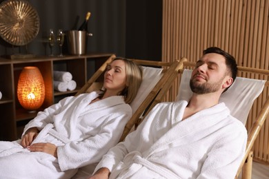 Couple in bathrobes relaxing in spa salon